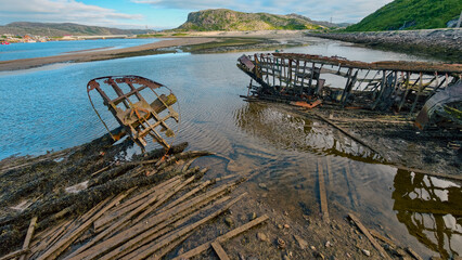 old abandoned sunken ship in the water at the ship cemetery wood pattern