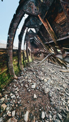 old abandoned sunken ship in the water at the ship cemetery wood pattern