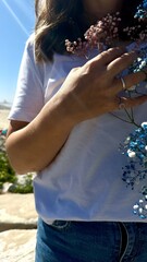 on the beach girl in a white t-shirt and jeans with flowers