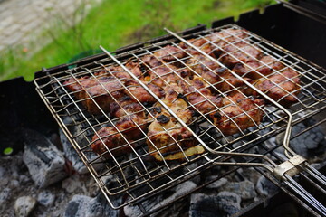 Juicy pork shish kebab sizzling on the grill over a barbecue in a country house, smoky barbecue with mouth-watering meat