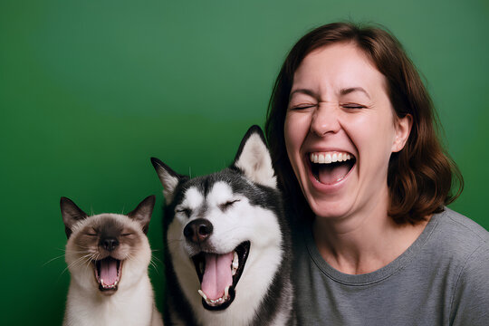 Joyful woman and pets share a moment of pure, infectious laughter