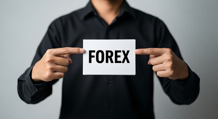 A person is holding a card with the word forex, representing currency exchange and trading