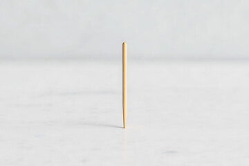 Minimalist toothpick shot on a white marble surface. Focus on simple design. Clean aesthetic. Light background. Wooden texture.