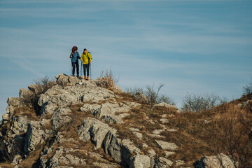 Hikers standing on mountain top enjoying scenic view