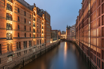 Blue hour long exposure of Hamburg’s Speicherstadt viewed from Kibbelsteg Bridge, featuring...