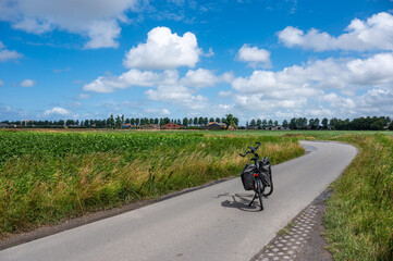 Bending road through the green agriculture fields in Ramskapelle, Knokke Heist, West Flanders Belgium