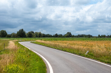 Swirling road through the golden wheat fields in Knokke Heist, West Flanders, Belgium
