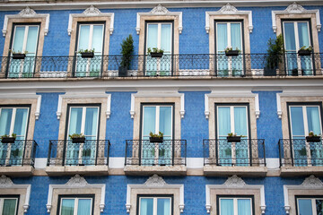 Obraz premium Blue tiled facade with balconies and windows in Lisbon, Portugal