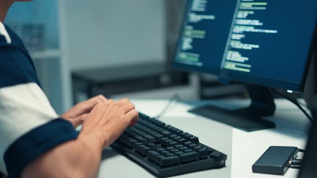 Close-up of software engineer typing source code for cybersecurity system, focusing on backend logic, data protection, and secure programming process.