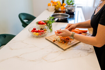 Woman Cooking Healthy Meatballs and Vegetables in Contemporary Kitchen with Fresh Ingredients