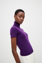 Young Black Woman in Purple Turtleneck Sweater - Studio Portrait