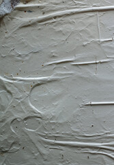 Detailed close-up of white poster paper with visible wrinkles, folds, and slight tears.