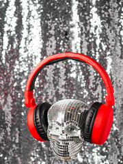 Party scull made of small mirrors wearing colorful headphone. Abstract super DJ concept. Fan of...