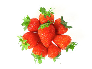 Fresh and juicy red strawberry in a pile on white background. Premium high quality organic product. Food supply industry.