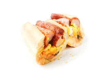 Traditional tasty Irish breakfast roll with white bread, sausage, bacon or rasher, fried egg and black pudding on greasy wrapping paper. Popular high calorie meal in Ireland. Classic dish