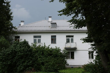 The serene and picturesque White House is beautifully surrounded by lush greenery and trees