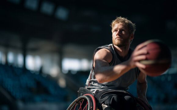 Focused Male Wheelchair Basketball Player Making A Powerful Pass During Indoor Competition Game