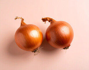 Two Fresh Onions Against a Soft Pink Background