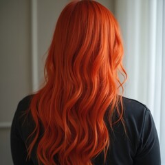 Fototapeta premium Woman vibrant red-orange hair from back view. Long, wavy, dyed hair style. Healthy, attractive hair for fashion and beauty. Shows hair care, coloring, salon treatment.
