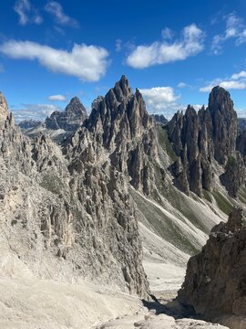 Sharp Rocky Peaks in the Dolomites &ndash; Dramatic Mountain Landscape on a Hiking Trail toward Tre Cime di Lavaredo, Italy, with Rugged Cliffs and Striking Rock Formations under a Clear Summer Sky