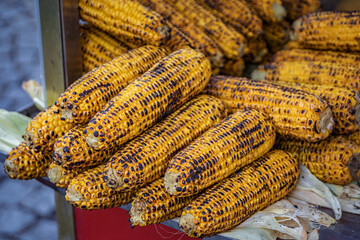 Popular Turkish street food, misir, freshly boiled sweet corn on the cob, roasted on a coal grill...
