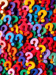 A colorful and chaotic pattern of question marks, creating a visually stimulating and abstract background.