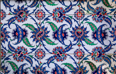 Ornate blue and red handmade Turkish Iznik mosaic tiles with floral Islamic patterns in a traditional Ottoman style in Istanbul, Turkey