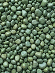many small green stones uneven background