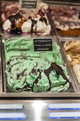 Picture of an italian ice cream shop, Menth and chocolate ice cream looking very tasteful.