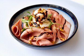 Deliciously Crafted Dish Featuring Delicate Ham, Creamy Ice Cream, and Crunchy Nuts Served in a Stylish Bowl with Garnish