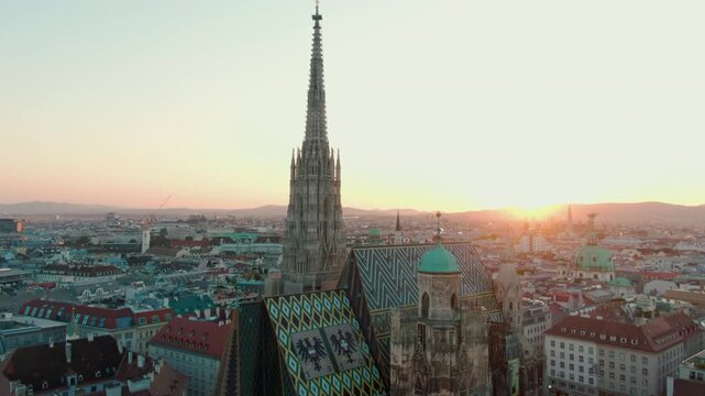 Drone shot of St. Stephens Cathedral in central Vienna, surrounded by historic buildings and rooftops. Perfect for travel media, documentaries, or cultural city visuals. 4K aerial medium orbit view