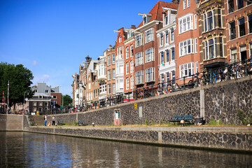 Scenic view of Amsterdam Canal with residential houses and bicycles against railings.