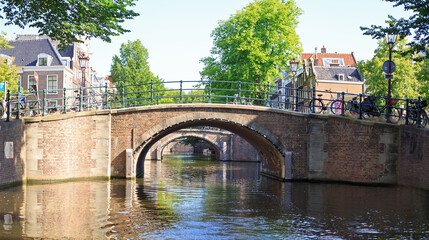 Scenic cruise on Amstel River -  Amsterdams canal, with arched bridges