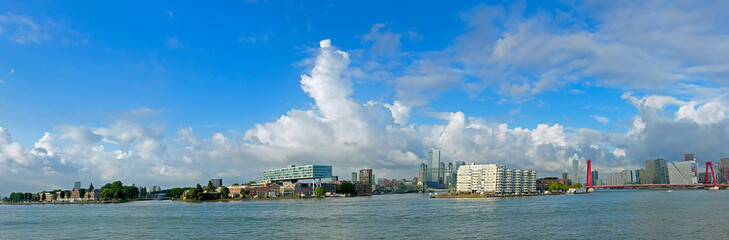 Panoramic view of Rotterdam Harbour located on the Rhine River with a lovely blue cloudy sky
