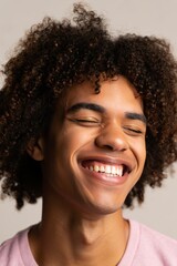 Young Man with Curly Hair Laughing Joyfully