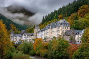 Autumnal village nestled in a valley, with colorful foliage and misty mountains