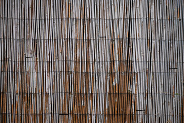 Weathered Bamboo Fence with Vertical Slats and Rustic Texture