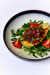 Colorful and Flavorful Dish of Grilled Avocado Topped with Fresh Salsa, Garnished with Tomato and Greens on a Elegant Plate