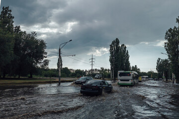 Cars on flooded road, disaster at city