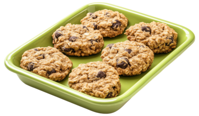 Freshly baked chocolate chip oatmeal cookies on a green tray isolated on transparent background.
