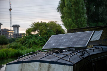 Solar Panel on Boat Roof in Nature with Industrial Background