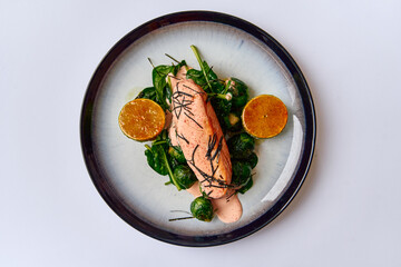A Deliciously Plated Salmon Fillet with Spinach and Citrus Garnish, Showcasing Culinary Artistry and Fresh Ingredients in Every Bite