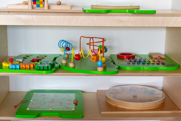 Montessori Educational Toys on Wooden Shelf in Preschool Classroom, sustainable eco toys