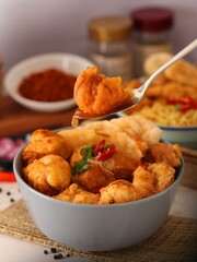Cuanki with Sauce and Fresh Garnish on Orange Plate