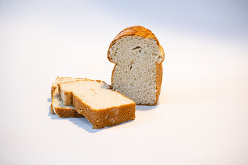 Pan artesanal recién horneado, con corteza dorada y miga esponjosa, presentado sobre fondo blanco. Ideal para representar comida casera, cocina tradicional y productos de panadería natural.