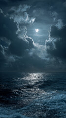 A dark stormy night over the ocean with receding storm clouds full moon + churning waves weather anger sadness depression mental illness sense of loss concepts danger background nature copy space
