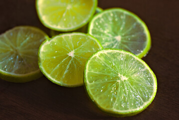 Lemon slices. Close-up of several slices of green lemon fruit 
