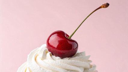 Whipped cream with cherry on top on pink pastel background associate to cherry picking, the best