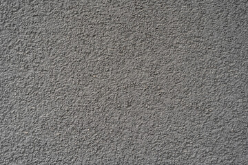 Rough gray concrete wall surface with visible grain and texture. Suitable for backgrounds, design...