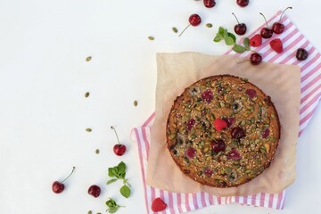 Banana bread, banana muffin, seeds, raspberries, pumpkin seeds, chia, flax, sesame, homemade baking on a white table, free space